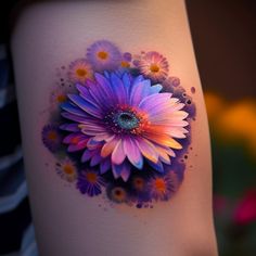 a colorful flower on the side of a woman's thigh