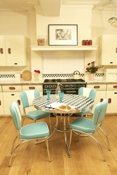 a kitchen table with four chairs and a checkerboard pattern on the table top