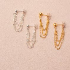 Our dangle chain earrings are a fun accessory that can be worn anywhere, from holiday parties to work. Pair them with any outfit for the perfect balance of fun and flirty. These minimalist earrings also make a very thoughtful birthday gift for the minimalist. …………………………………. Details: Chain is 14K Gold Filled or Sterling Silver Stud is 14k Gold Filled, measuring 4mm or Sterling Silver measuring 3mm Waterproof and can be worn all the time Perfect for Sensitive Ears About Your Jewelry If you are not Elegant Dangle Cartilage Earrings With Adjustable Chain, Elegant Dangle Chain Cartilage Earrings, Dainty Silver Threader Earrings For Party, Dainty Sterling Silver Chain Earrings, Elegant Dangle Cartilage Earrings With Delicate Chain, Elegant Delicate Chain Dangle Cartilage Earrings, Sterling Silver Threader Dangle Earrings For Party, Dainty Single Cartilage Earring For Party, Trendy Dangle Cartilage Earrings For Party