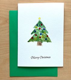 a card with a watercolor christmas tree on it