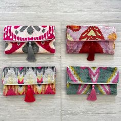 four different clutches with tassels on them