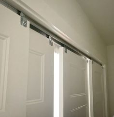 an open sliding door in a white room