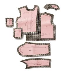 some pink and black pieces of clothing on a white surface with one piece cut out to show it's size