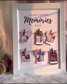 a white frame with pictures hanging from clothes pins on it and the words i never want to be making memories with you