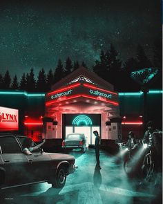 a man standing in front of a gas station at night with cars parked outside it