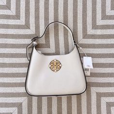 Authentic Tory Burch Miller Classic Shoulder Bag/Hobo. In Brand New Condition With Tag And Dust Bag. Detachable And Adjustable Long Shoulder Strap. Can Be Worn As Shoulder Or Crossbody Bag. Open Top With Magnetic Closure. Color: New Ivory Style: 82982 Designer Rectangular Hobo Bag With Branded Hardware, Designer White Hobo Bag, Luxury Cream Hobo Bag With Gold-tone Hardware, Designer White Hobo Bag For Shopping, Elegant Tan Hobo Shoulder Bag, Elegant Tan Hobo Bag For Daily Use, Elegant White Hobo Bag, Elegant Beige Hobo Bag With Silver-tone Hardware, Modern White Hobo Bag With Gold-tone Hardware