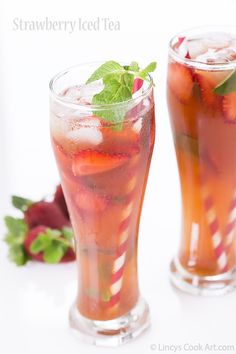 two glasses filled with ice tea and strawberries