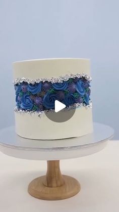 a white cake with blue flowers on it