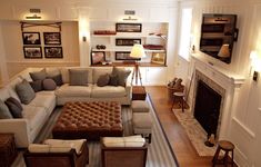 a living room filled with furniture and a fire place in the middle of a room