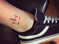 a woman's foot with an arrow tattoo on it