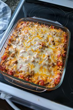 a casserole dish with meat and cheese in it on top of an oven