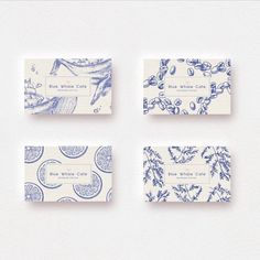 four business cards with blue and white designs on them, all in different shapes and sizes