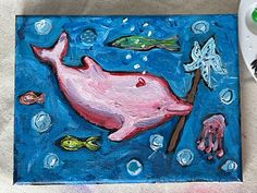 a painting of a pink whale and fish on a blue background