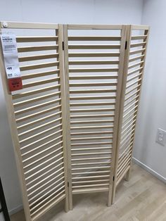 a room divider made out of wooden slats