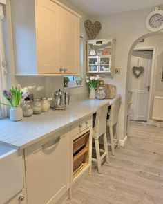 a kitchen with lots of counter space and white cabinets