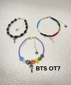 BTS OT7 inspired bracelets with #7charm. Three designs to choose from. First one with all the mic colors in beads. Second is the flower inspired and last is the black swan inspired OT7.  Color in the photo can be slightly different due to lighting, photo processing and various circumstances, but rest assured you are getting well-crafted jewelry. Can be customized according to your needs. For more info about this listing, send me a message and I will answer as soon as I can. FYI, no refund is acc Handmade Multicolor Beaded Bracelets Kpop Style, Bts Bracelet Beads, Multicolor Round Beads Kpop Jewelry, Handmade Black Beaded Kpop Bracelet, Jimin Bracelet Beads, Kpop Style Custom Name Bracelets As Gift, Bts Charm Bracelet, Wired Glass, Photo Processing