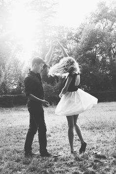 a man standing next to a woman in a field