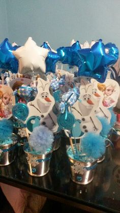 there is a table full of frozen princess decorations on it's glass trays