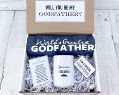 a white coffee mug in a gift box that says, will you be my godfather?