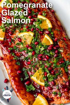 salmon with pomegranate glaze and garnished with lemon wedges