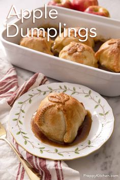 apple dumplings on a plate with apples in the background