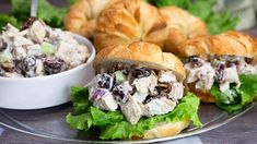 two croissant sandwiches with chicken salad on them