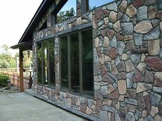 a building made out of rocks with windows