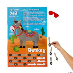 a hand is holding scissors and pointing at a donkey on the side of a poster