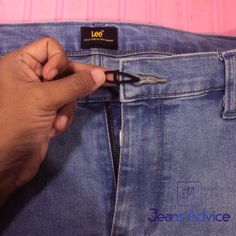 someone is cutting through the back pocket of their jean's advice jeans with scissors