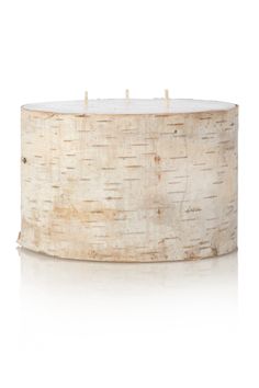 a white candle sitting on top of a wooden table