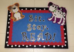 a sign that says sit stay read with dogs and cats on the front, along with polka dot border