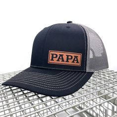 Introducing our Leather Patch PAPA Hat -- The Richardson 112 Hat is a classic and versatile accessory that combines style and functionality. Featuring a structured fit, a pre-curved visor, and an adjustable snapback closure, this hat provides a comfortable and customizable fit. Its timeless design, along with various color options, makes the Richardson 112 a go-to choice for casual wear, outdoor activities, or sports. Crafted with attention to detail, it's a reliable and stylish addition to any wardrobe. THE HAT: Classic trucker cap style built with the Richardson quality and fit you've come to expect. The Richardson 112 remains a best-seller and favorite cap for teams, fans, and brands alike. Richardson 112 Fabric: Cotton-Poly/Nylon Mesh Visor: Pre-curved Sweatband: Cotton Fit: Adjustable Father's Day Gift Snapback Hat With Curved Brim, Father's Day Gift Trucker Hat With Curved Brim, Adjustable Flat Bill Snapback Hat For Father's Day, Adjustable Brown Hats For Birthday, Classic Curved Brim Hat As A Gift, Classic Curved Brim Hat, Trucker Hat With Letter Print For Gift, Personalized Hats For Father's Day, Curved Brim Baseball Cap For Father's Day