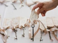 a person holding a bunch of keys on top of a table