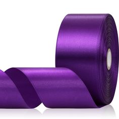 two rolls of purple satin ribbon on a white background with reflection in the bottom right corner