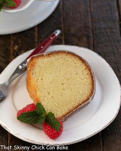 a slice of pound cake on a plate with raspberries