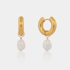 Simple yet sophisticated, our Audrey Pearl Drop Hoops are a true wardrobe staple. They are perfect for wearing on their own or stacked with our other earrings. You are able to detach the pearls for a completely different look. The Audrey Pearl Drop Hoops feature a heavy 18k gold plated stainless steel hoop and a freshwater pearl, these earrings are made to last. Hoop Measurements: Inner Diameter: 10mm Thickness: 5mm Hypoallergenic Freshwater pearls vary in size/shape/color Classic Gold Pearl Huggie Earrings, Formal Gold Huggie Earrings With Pearl Drop, Classic Gold Hoop Earrings With Pearl Chain, Modern Gold Pearl Earrings With Pearl Charm, Modern Gold Hoop Earrings With Pearl Charm, Gold Pearl Earrings Tarnish Resistant, Luxury Gold Hoop Earrings With Pearl Drop, Brazilian Gold, White Freshwater Pearl