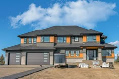 a two story house with orange and gray trim