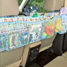 the back seat of a car with stuffed animals hanging from it's side rail