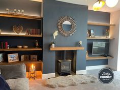 This is a gorgeous and cosy living room, a rich blue tone has been used on the walls and within the alcoves, our solid wood shelves have been used to utilise space. LED lights have been placed at the back of the shelves which gives the illusion that they are glowing and the full look has been brought together with one of our solid oak mantels which sits proudly in the centre of the wall above the log burner. Living Room Design Blue, Alcove Ideas Living Room, Alcove Storage, Alcove Shelving, Navy Living Rooms, Feature Wall Living Room, Snug Room, Wood Shelving