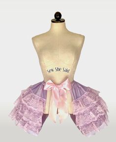 Made with satin and detailed with lace ruffles. Constructed with lightweight boning and has an adjustable 60" ribbon waist tie. This pannier set can be worn over or under your lightweight skirt to create a stunning silhouette.  Shown in lavender satin and pink lace. Elegant Pink Ruffled Petticoat, Lace Tiered Petticoat With Attached Cancan, Lace Petticoat With Attached Cancan, Tiered Skirt, Lace Petticoat With Lace Trim And Tiered Skirt, Fitted Lace Petticoat With Lace Trim, Fitted Lace Petticoat With Attached Cancan, Elegant Lace Petticoat With Ruffled Skirt, Party Petticoat With Lace Ruffles, Ruffled Lace Petticoat For Wedding