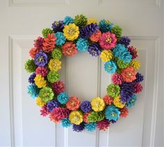 a colorful wreath made out of paper flowers