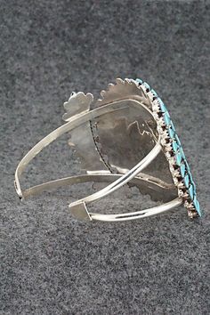 This stunning turquoise and sterling silver bracelet was made by Zuni silversmith Merlinda Chavez. The inside is signed D & M Chavez and Zuni.Size: 5 1/2" (will fit up to a 6 3/4" wrist)Gap: 1 1/4"Width: 2"Free shipping on all orders! We ship with USPS and always include tracking. All orders ship within a day of payment.Returns are accepted up to 30 days after you receive your order. Just send us a message. Our shop offers cash back or store credit. The item must be returned in new condition. Unique Turquoise Jewelry With Polished Finish, Elegant Turquoise Bracelet With Inlay, Elegant Turquoise Inlay Bracelet, Adjustable Turquoise Bracelet With Inlay, Adjustable Turquoise Inlay Bracelets, Round Turquoise Sterling Silver Cuff Bracelet, Unique Turquoise Sterling Silver Bracelets, Blue Inlay Bracelet Jewelry, Blue Inlay Bracelet