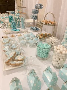 a table topped with lots of blue and white desserts