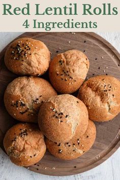 a wooden plate topped with muffins on top of a table