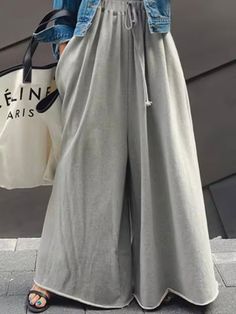 Casual style. European design. Elastic waist. Drawstring. Side pockets. Loose fit. High rise. Long length. Raw edge. Wide flare leg. 80% Cotton and 20% polyester. Color may be lighter or darker depending of the device it is displayed. Gray High-waist Pants, Baggy Gray High-waisted Pants, Gray Baggy High-waisted Pants, Gray Full Length Drawstring Bottoms, Trendy Gray Pants With Drawstring, Gray Stretch Bottoms With Drawstring, Gray Wide Leg Drawstring Bottoms, Gray Wide Leg Bottoms With Drawstring, Gray High-waist Drawstring Pants