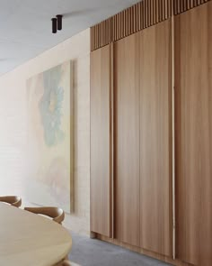 a large wooden table sitting in front of a wall with sliding doors on it's sides