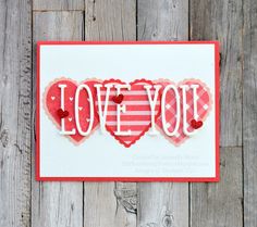 a card with the word love you written in red and white on top of it