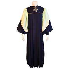 a priest's robe is shown on a mannequin head, with the letters tp in gold and black