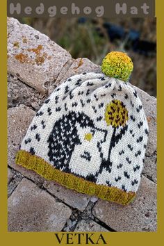 a knitted hat sitting on top of a stone wall