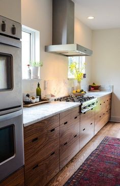 a kitchen with wooden cabinets and stainless steel appliances